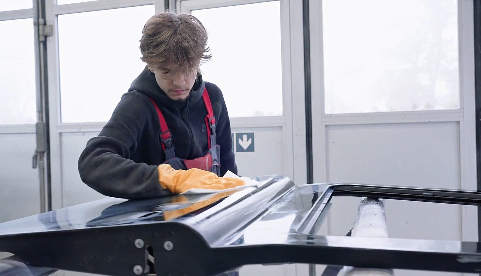 Apprenti en pleine finition d’un élément de carrosserie